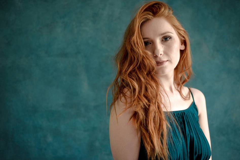 A woman with elegant hair lowlights smiling confidently