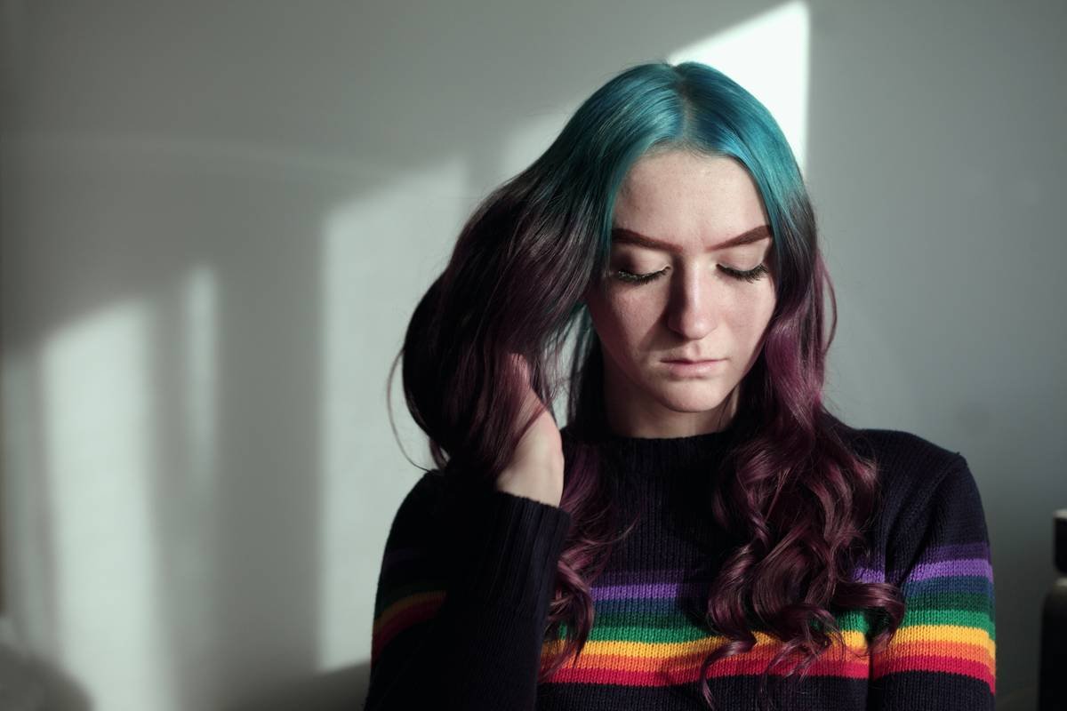 Infographic showing how lowlights create dimension by mimicking natural shadow patterns in layered hair