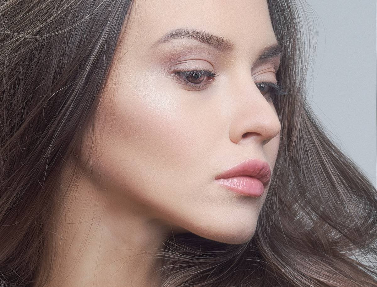 Diagram showing how lowlights create depth in hair by adding 2-3 shades darker strands beneath base color for natural shadow effect